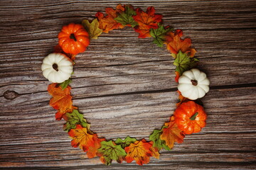 Flat lay colorful autumn Maple leaves border on wooden background
