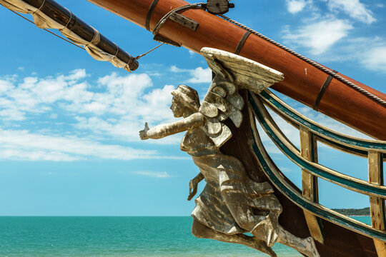 Figurehead (nose shape) is an ornament on nose of sailing vessel, rostrum or caryatid. Wooden sculpture of goddess of victory, Nick, brought happiness and luck to ancient wood sailboat Statue of luck