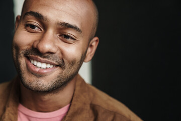 Obraz premium Image of smiling african american guy looking aside