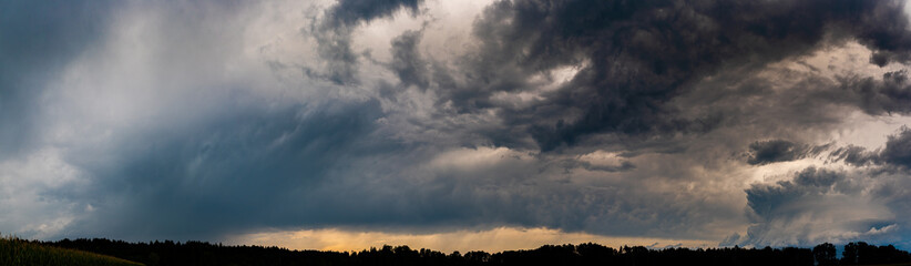 Fototapeta na wymiar Stormy and dramatic sky panorama of rural area.