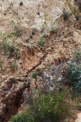 Landslide zone on Black Sea coast. Rock of sea rock shell. Zone of natural disasters during rainy season. Large masses of earth slip along slope of hill, destroy houses. Landslide - threat to life