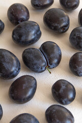 Fototapeta na wymiar fresh dark blue plum on white background