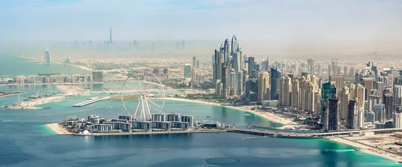 Fotobehang Panoramic aerial view of Dubai Marina skyline with Dubai Eye ferris wheel, United Arab Emirates © Delphotostock