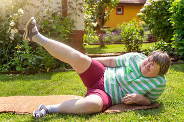 mentally disabled woman is doing some assisted exercises