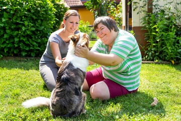 mentally disabled woman with a second woman and a companion dog