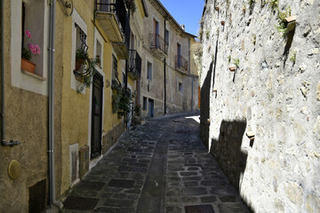 Fototapeta na wymiar A small road crosses the old buildings of Calvello, a old Town in the Basilicata region, Italy. 