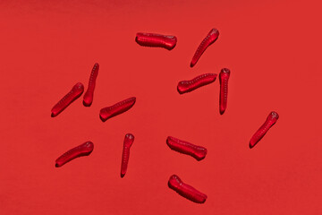 red jelly worms pattern with shadow on a red background