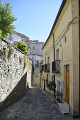 Fototapeta na wymiar A small road crosses the old buildings of Calvello, a old Town in the Basilicata region, Italy.