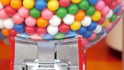 Colorful gumballs in classic vending machine, USA. Multi colored buble gums, coin operated retro...