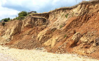 Landslide zone on Black Sea coast. Rock of sea rock shell. Zone of natural disasters during rainy season. Large masses of earth slip along slope of hill, destroy houses. Landslide - threat to life