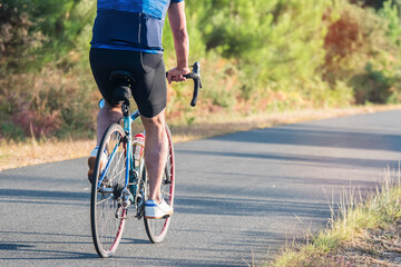 Naklejka premium mature cyclist in the Landes forest