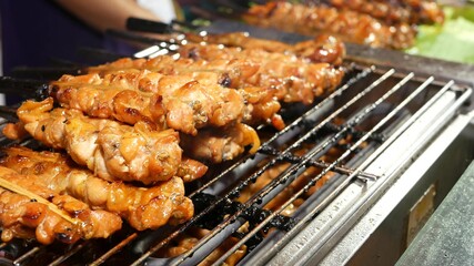 Meat kebabs frying on street. Set of yummy meat kebabs grilling on grating in traditional street cafe in Thailand.