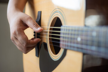 man playing acoustic guitar