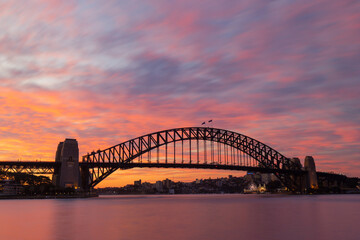 Colorful sunset sky over Sydney Harbour Bridge.