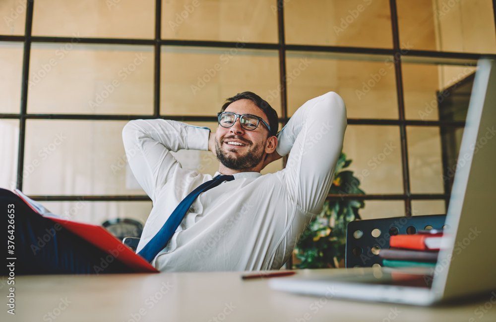 Aufkleber skilled entrepreneur in optical spectacles smiling at camera during work day at table desktop with m