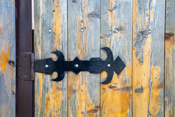 vintage hinge on a wooden door in an abandoned old house
