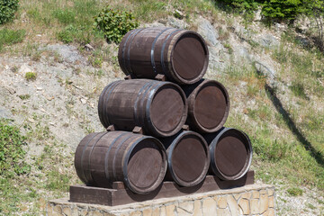 Advertising design from old oak barrels on the edge of vineyards and winery. Countryside of Russia Abrau-Dyurso. Traditional view of the vineyards in the fields with vineyards and winemakers