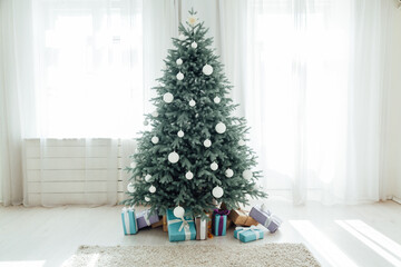 The interior of the white room with a blue Christmas tree with gifts for the new year decor winter postcard