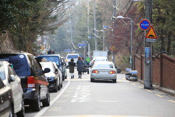 Vehicles and crowds on the road in the city