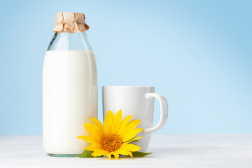 Milk in glass bottle and cup