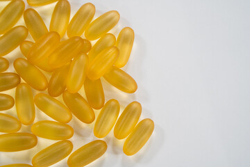 Close up the vitamin D and Omega 3 fish oil capsules supplement for good brain , heart and health eating benefit