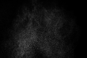 Abstract splashes of water on black background. Freeze motion of white particles. Rain, snow overlay texture.