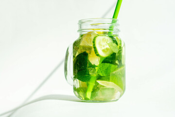 Health care, fitness, healthy nutrition diet concept. Fresh cool lemon cucumber mint infused water, cocktail, detox drink, lemonade in a glass jar.