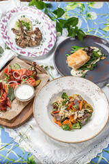 Set of four meat and fish dishes Business lunch combo on the table at restaurant