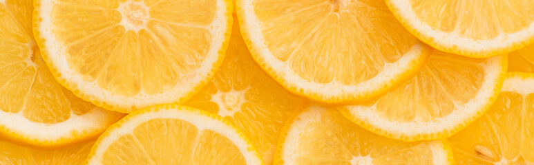 top view of sliced fresh and ripe yellow lemons, panoramic shot