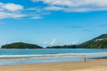 Fototapeta na wymiar Strolling on beach shore in Brazil in a sunny summer day
