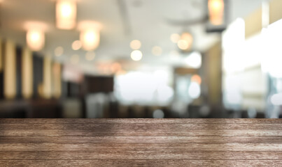 Wooden top table with bokeh light effect and blur restaurant on background, blur background