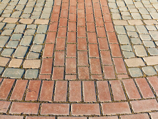 Sidewalk tile. Close-up paving slabs by mosaic. Road paving, construction. Colored concrete paving slab. Diagonal.