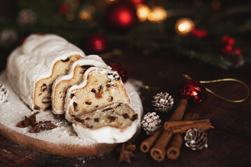 Traditional German Christmas cake - Cranberry Stollen, Christmas tree, ornaments, and candles.