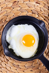 Fried egg. Close up view of the fried egg on a frying pan