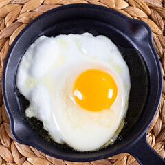 Fried egg. Close up view of the fried egg on a frying pan
