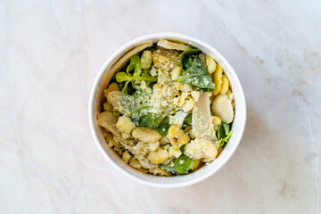Take Away Healthy Organic Vegetable Food Sliced Artichoke with Broad Beans, Purslane Salad, Grated Parmesan Cheese and Olive Oil in Plastic Cup Plate.