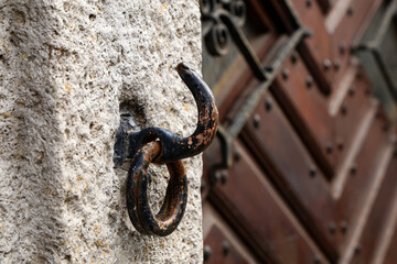 Old rusty hook with a ring at the gate