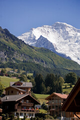 Fototapeta premium The village of Wengen above the Lauterbrunnen valley with the Jungfrau in the distance: Bernese Oberland, Switzerland 