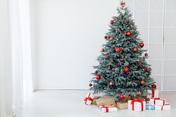 Blue Christmas tree with red decor gifts for the new year winter in the white holiday card room