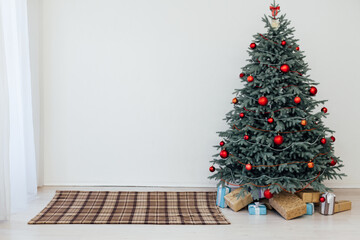 Blue Christmas tree with red decor gifts for the new year winter in the white holiday card room