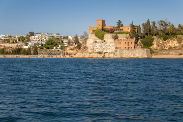 Fototapeta premium Fort of São João do Arade view from the river, a medieval fortification situated at Ferragudo typical village, in Algarve tourism destination region, Portugal.