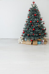 Blue Christmas tree with red decor gifts for the new year winter in the white holiday card room