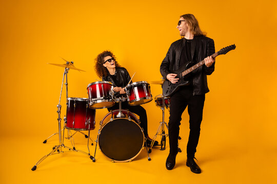 Full size photo of girlfriend boyfriend cool punk music players enjoy practice sound guitar drum solo wear leather black jacket glasses sunglass isolated over bright shine color background