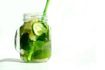 Health care, fitness, healthy nutrition diet concept. Fresh cool lemon cucumber mint infused water, cocktail, detox drink, lemonade in a glass jar.
