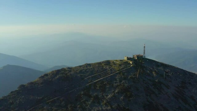 
Aerial shot Macedonia. Drone flying over Pelister Peak at sunset where you can see the station building on a background of beautiful mountain ranges in the haze.