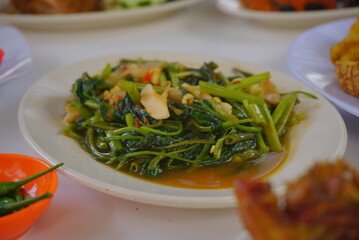 Close up of sauted kale on a white plate.