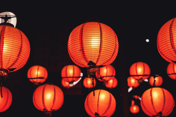 Beautiful round red lantern hanging on old traditional street, concept of Chinese lunar new year festival in Taiwan, close up. The undering word means blessing. © RomixImage