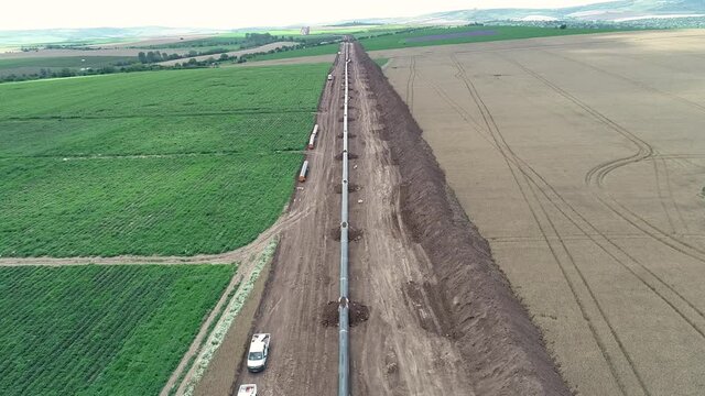 Aerial view of gas and oil pipeline construction. Pipes welded together. Big pipeline is under construction.