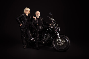 Obraz na płótnie Canvas Portrait of his he her she nice attractive trendy fashionable cool cheerful cheery grey-haired couple chopper travelers enjoying way road voyage trip tour isolated over black color background