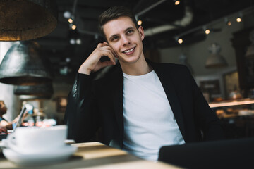 Cheerful businessman resting in cafe